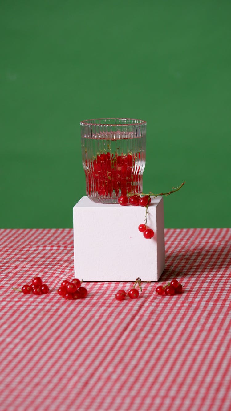 Currants In A Jar On A Table Covered With A Red Checkered Tablecloth 