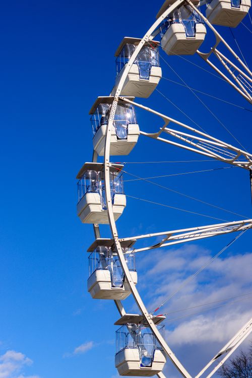 Free A vertical shot of a Ferris wheel in Osijek, Croatia, against a clear blue sky, capturing the essence of leisure and travel. Stock Photo
