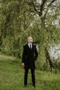 Man in Suit and Tie Standing in a Park