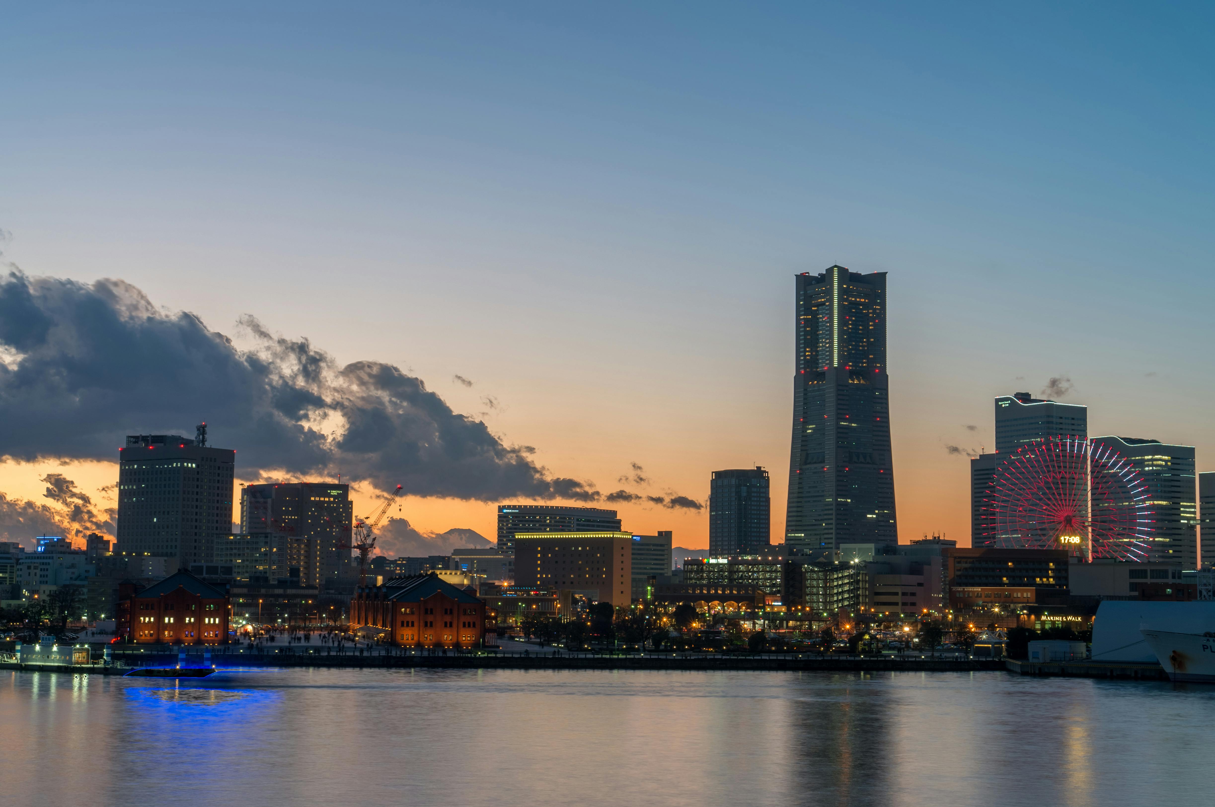 Captivating view of Yokohama skyline at twilight, featuring distinctive skyscrapers and city lights.