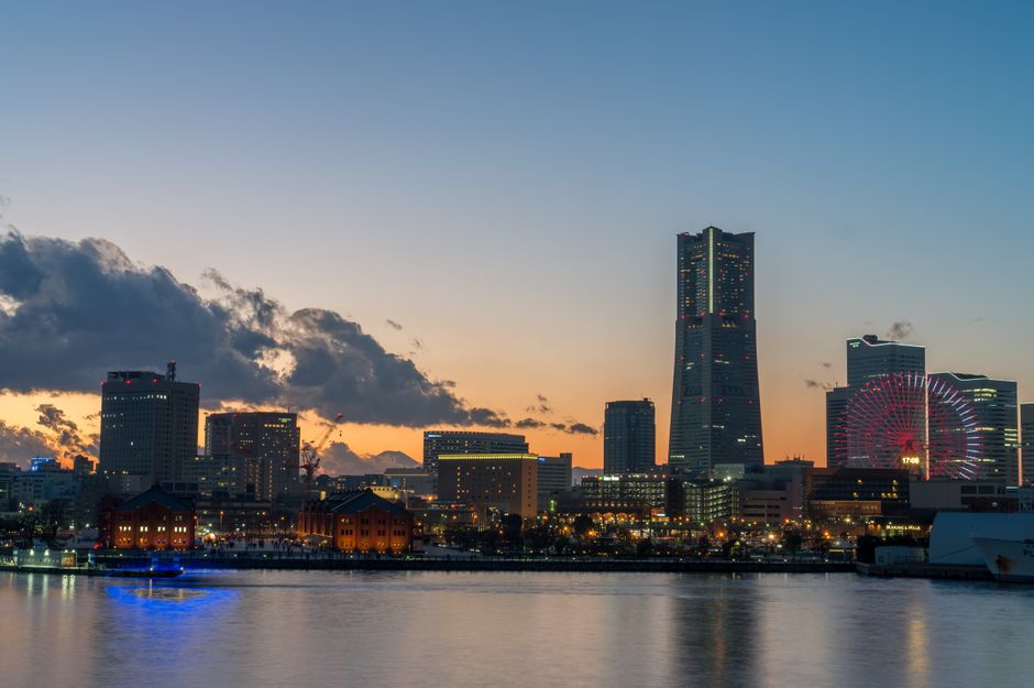 Captivating view of Yokohama skyline at twilight, featuring distinctive skyscrapers and city lights.