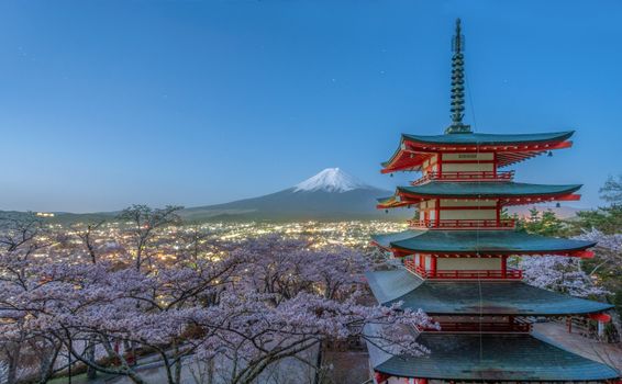 Scenic view of Chureito Pagoda and cherry blossoms with Mount Fuji in the background.