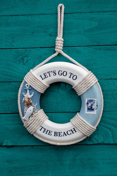 Free White and Blue Let's Go to the Beach Inflatable Ring Wreath Hanging Decor Stock Photo