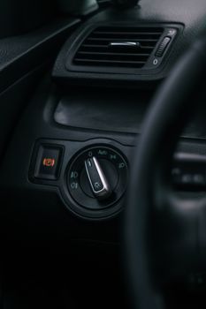 Detailed view of a car's light control switch, captured in Tarragona, Spain.