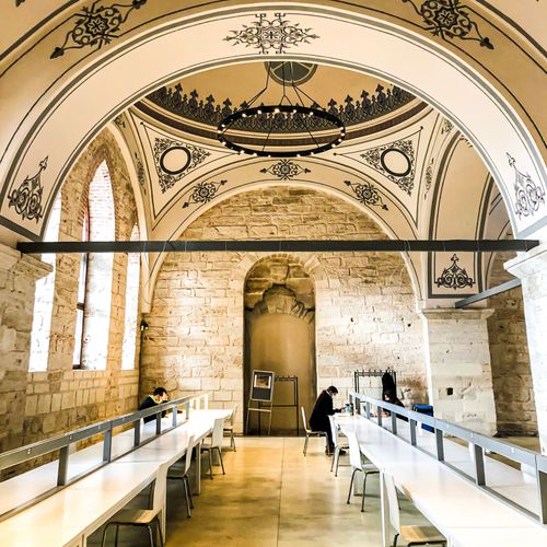Free Historic Beyazıt State Library's ornate interior with arches and seating in İstanbul, Turkey. Stock Photo