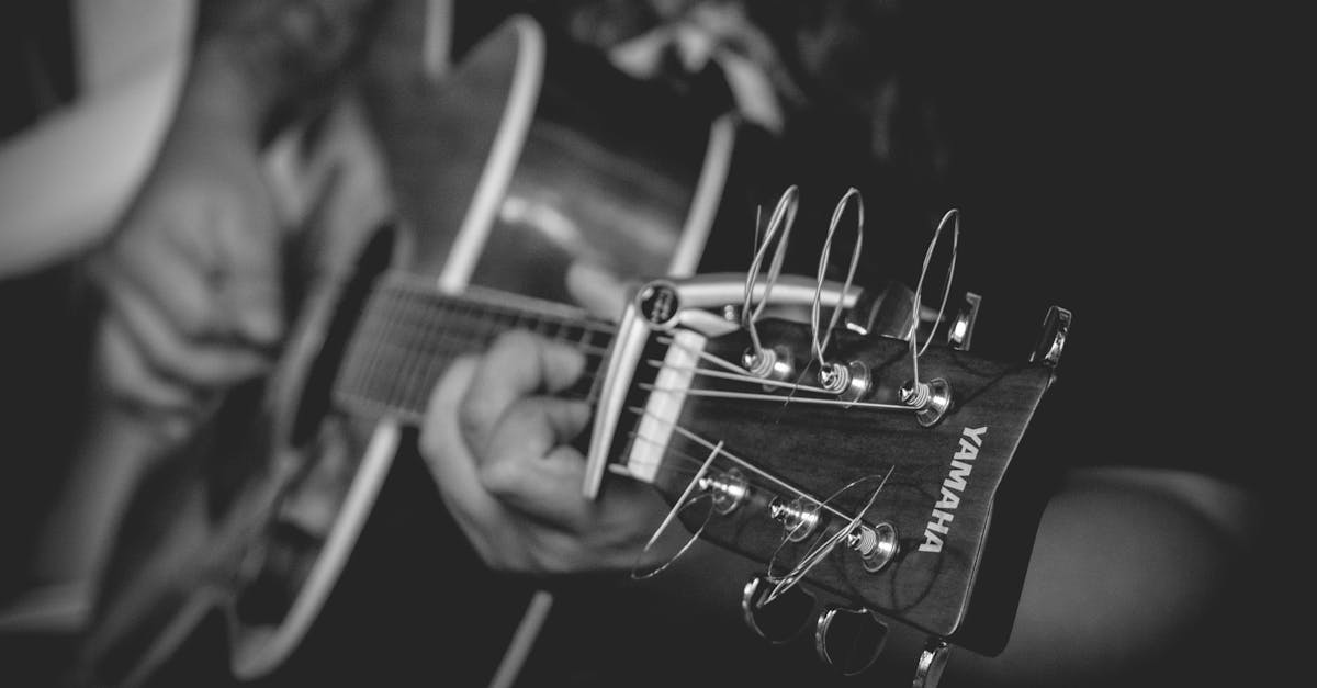 Grayscale Photography of Person Playing Yamaha Acoustic