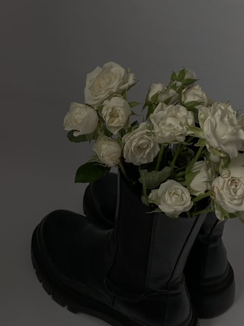 White Roses Bouquet on Black Leather Boots