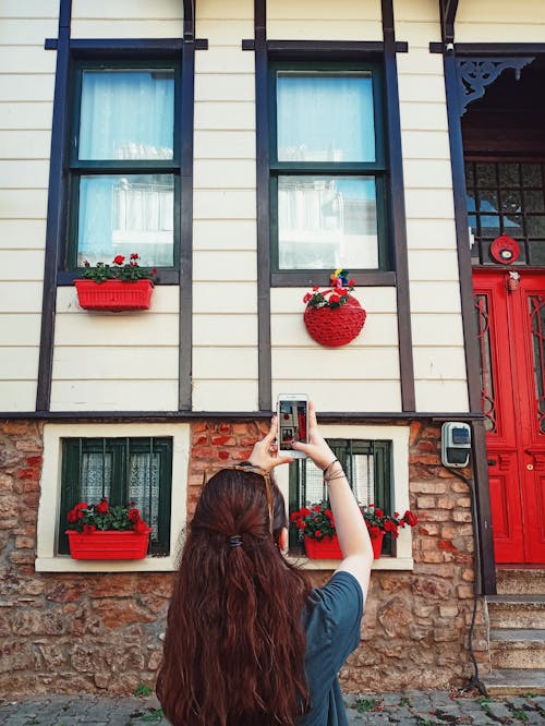 A Woman Taking Photo of the Building