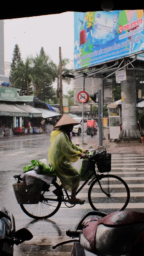 A Person Riding a Bike under the Rain