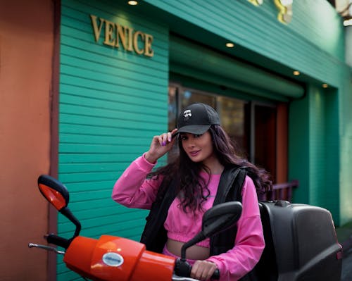 A Young Woman in a Trendy Outfit Sitting on a Motorcycle