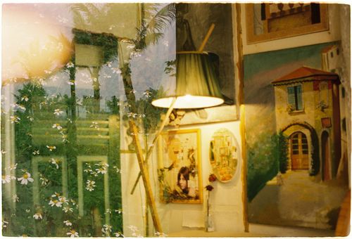 Free A creative interior space combining floral patterns with artistic paintings and soft lamp light. Stock Photo