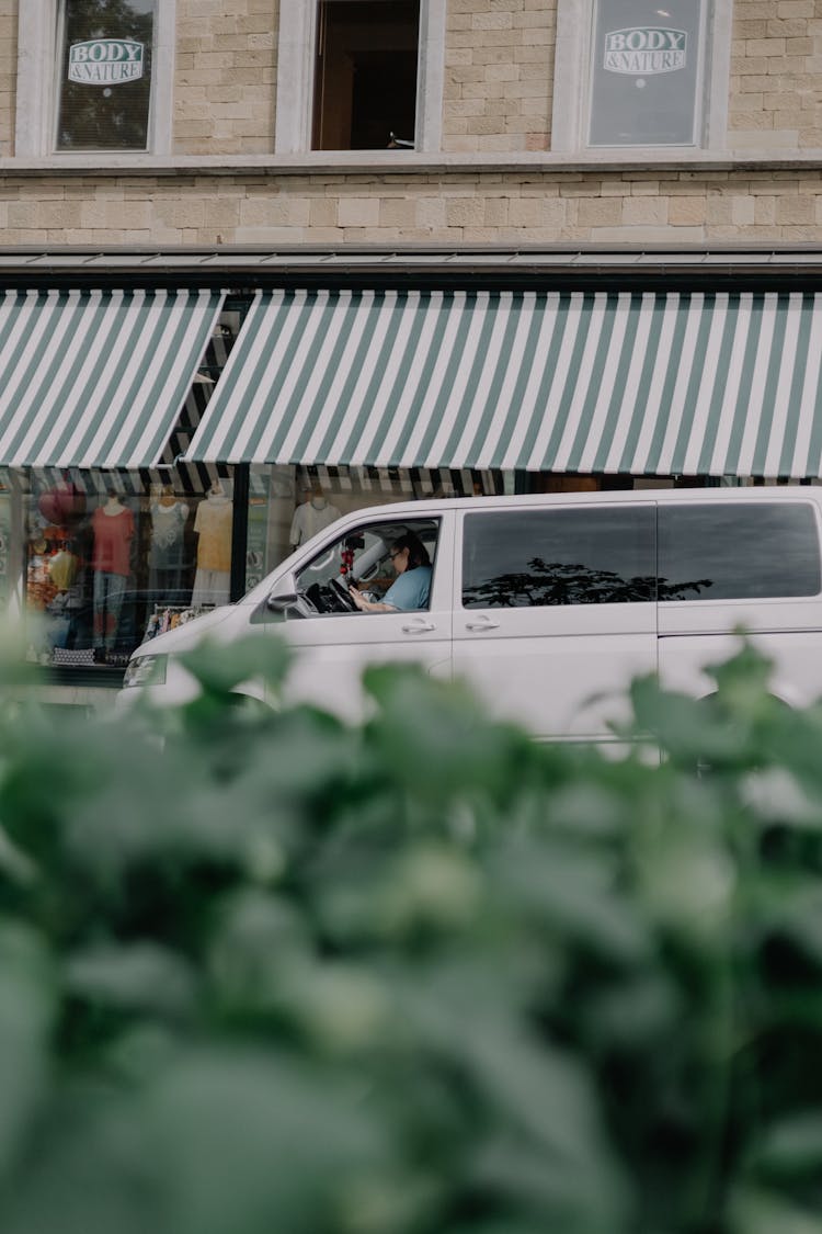 A Person Driving A White Van