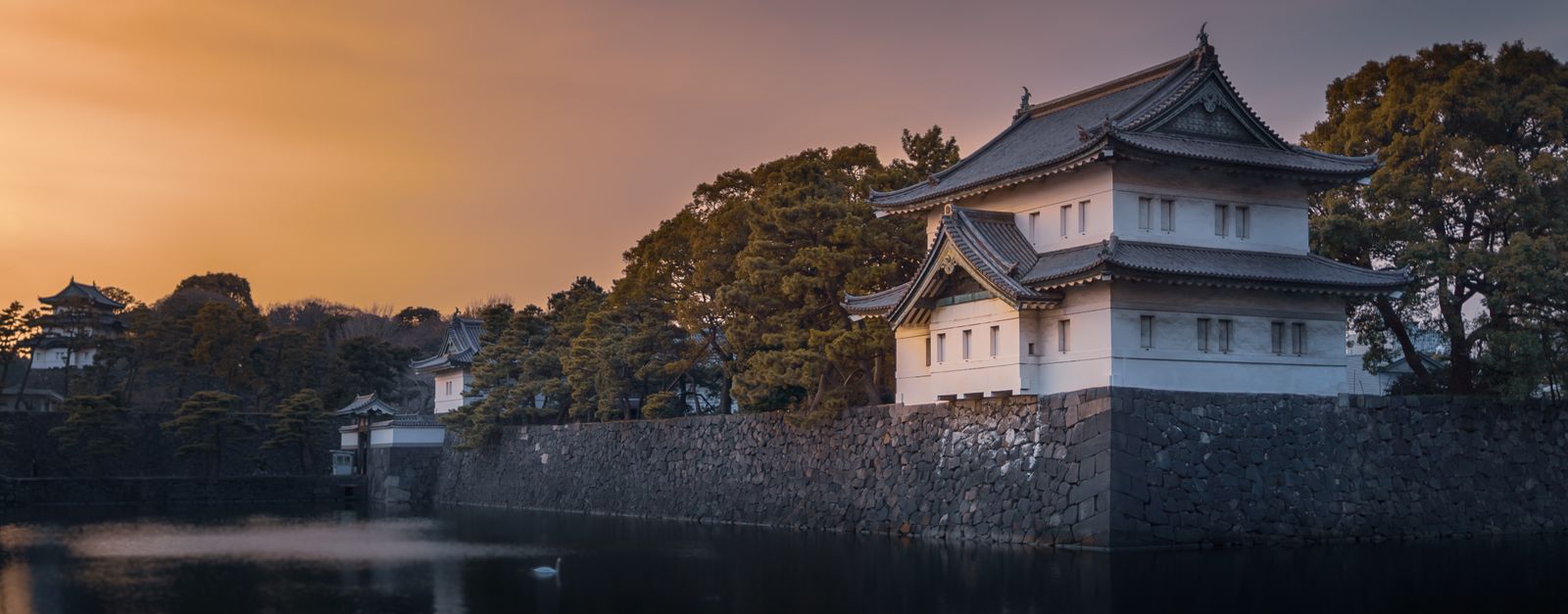 Serene view of the Imperial Palace and its moat during sunset in Tokyo, Japan.