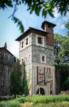 Historic medieval tower facade with ivy in Borgo Medievale, Turin, Italy.