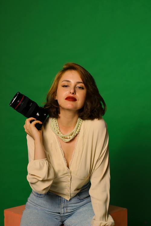 A Woman in Beige Long Sleeves Holding a Camera