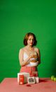 Woman in White Tank Top and Red and White Checked Skirt Holding White Ceramic Mug
