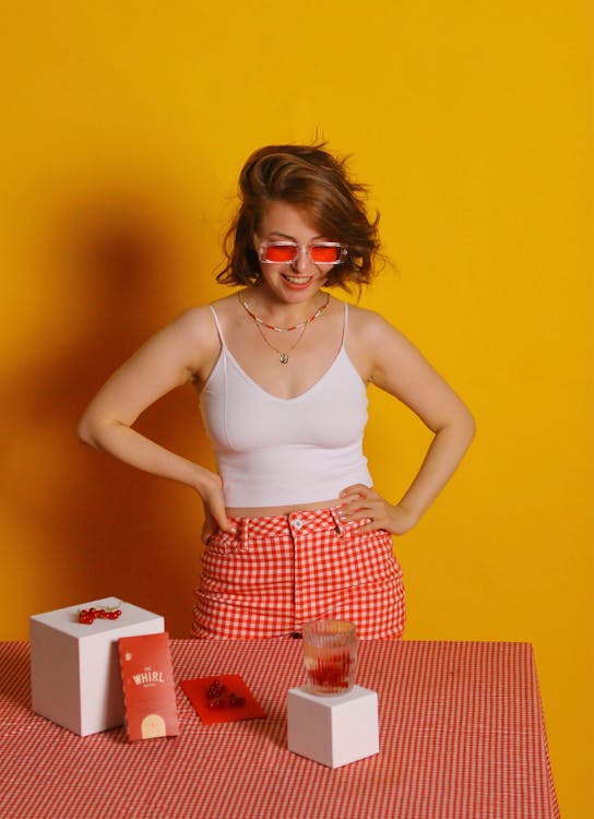 A Woman in White Tank Top and Red and White Plaid Skirt