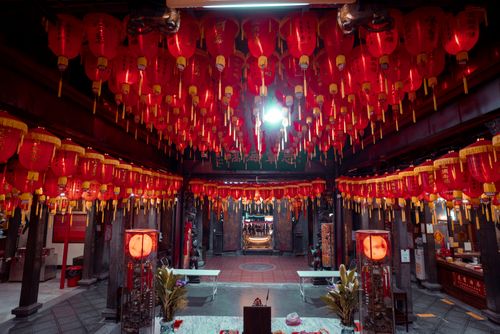 Free Vibrant red lanterns adorn the ceiling of a traditional Asian temple interior, cultural ambiance. Stock Photo