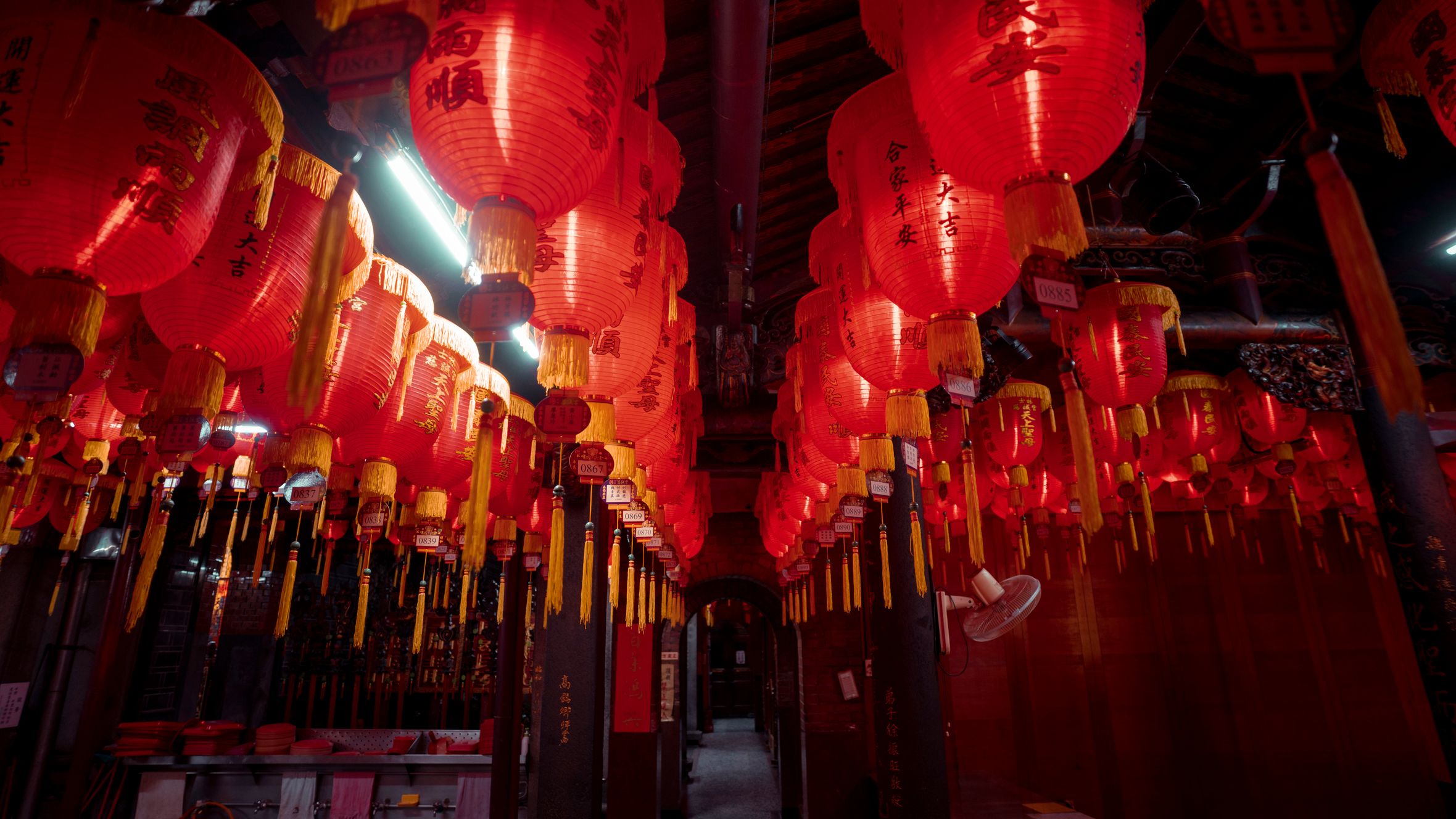 A captivating display of red Chinese lanterns in a traditional indoor space, showcasing cultural beauty.