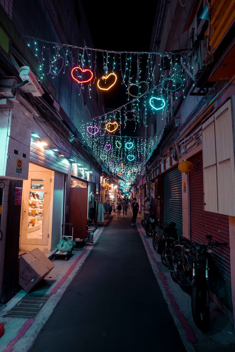 Heart Illuminations Hanging Over Narrow City Street