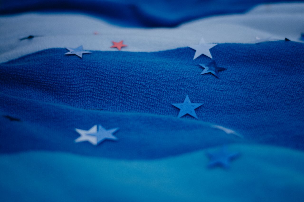 blue fabric with scattered star shapes creating abstract visual patter