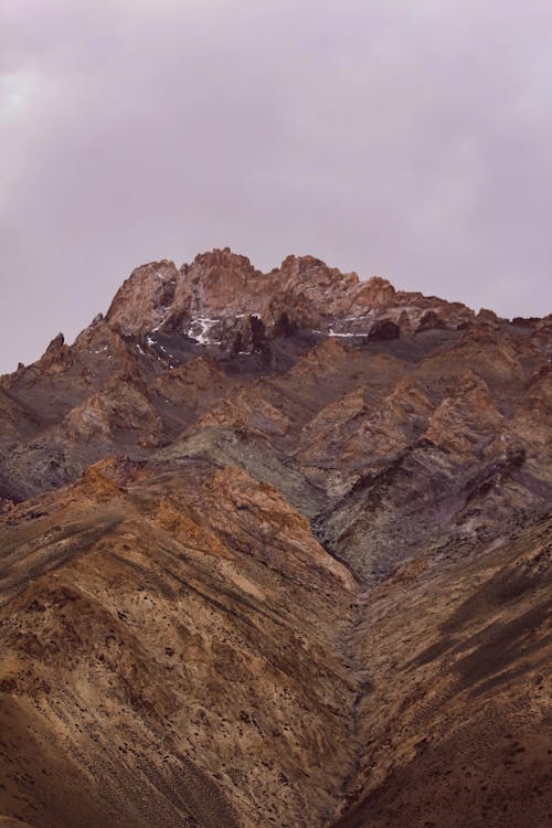 Brown Rocky Mountain Under Gray Sky