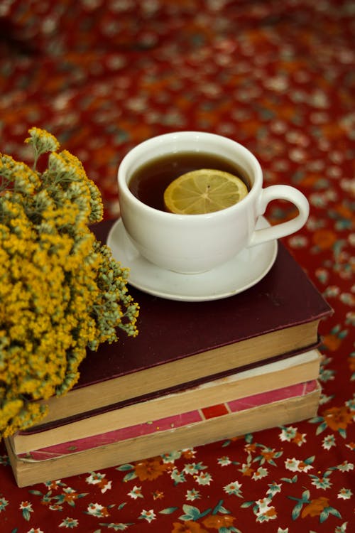 Tea in a Ceramic Cup on Top of stacked Books 