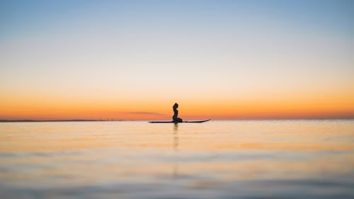 Horizon with a Silhouette of a Woman on a Surfboard