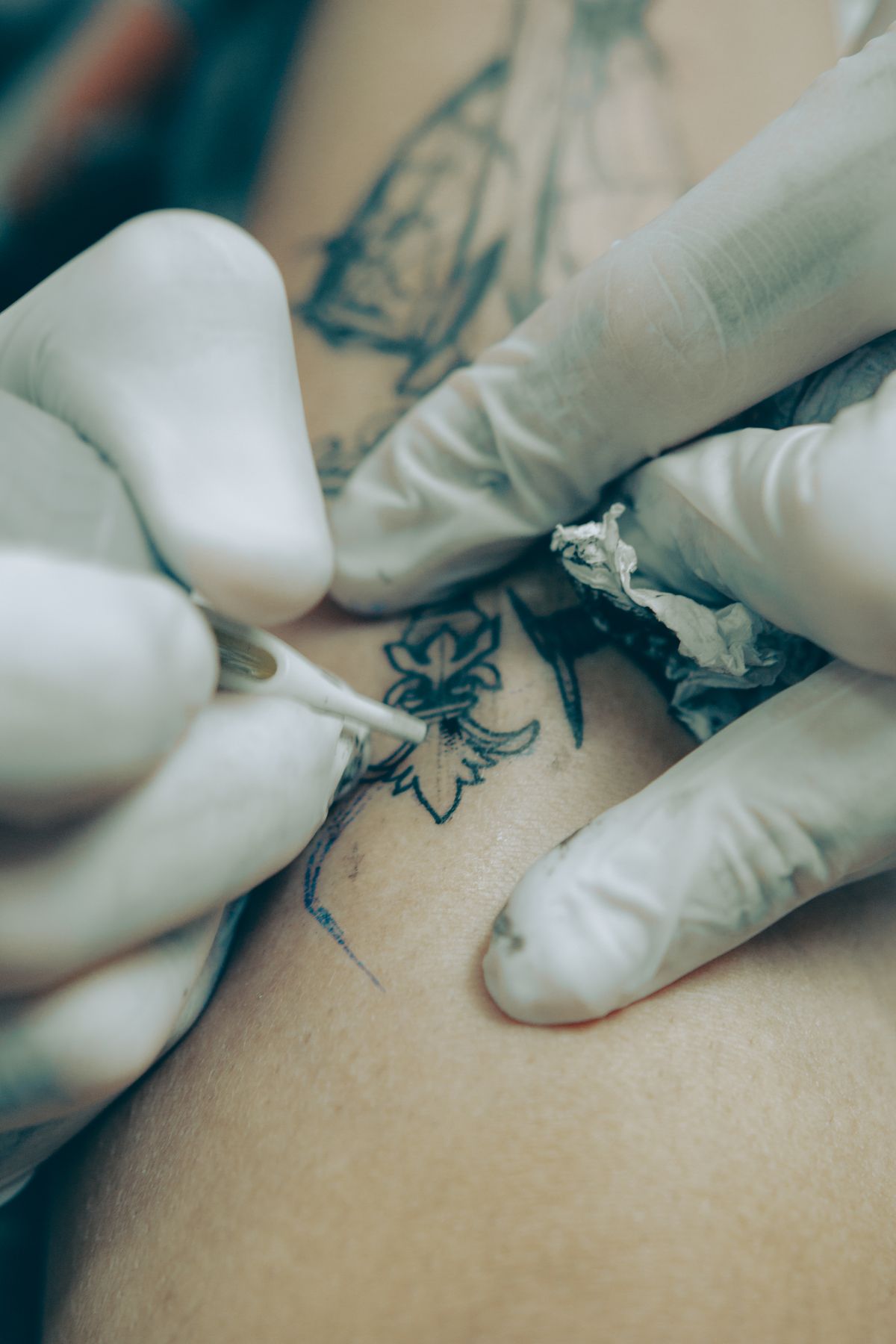 Artist wiping skin around a fresh stencil
