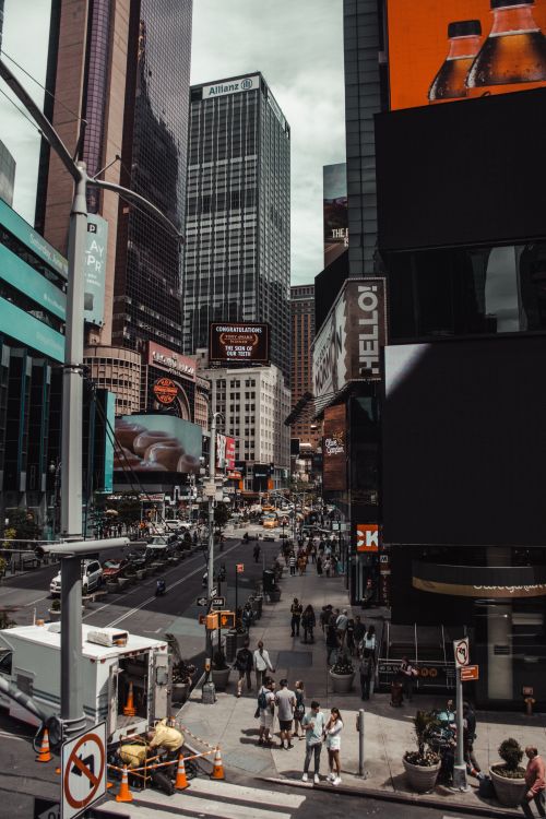 Free High-angle view of Times Square, New York City, with busy streets and towering skyscrapers under cloudy skies. Stock Photo