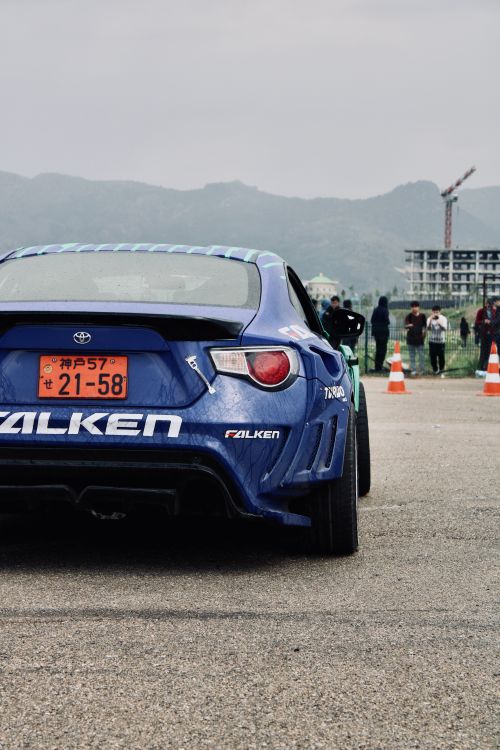 Free Dynamic shot of a blue sports car with striking decals, set against a mountainous backdrop in Turkey. Stock Photo