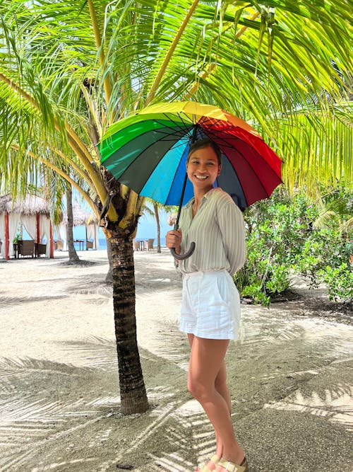 A Woman Holding Umbrella at the Beach