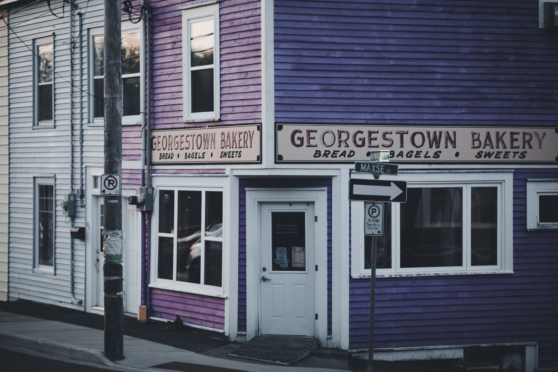 A cozy corner bakery in Georgetown, offering bread, bagels, and sweets with distinctive purple siding.