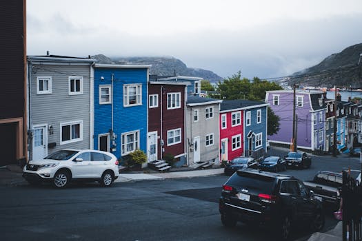 A scenic view of vibrant row houses on a hilly street, perfect urban landscape.