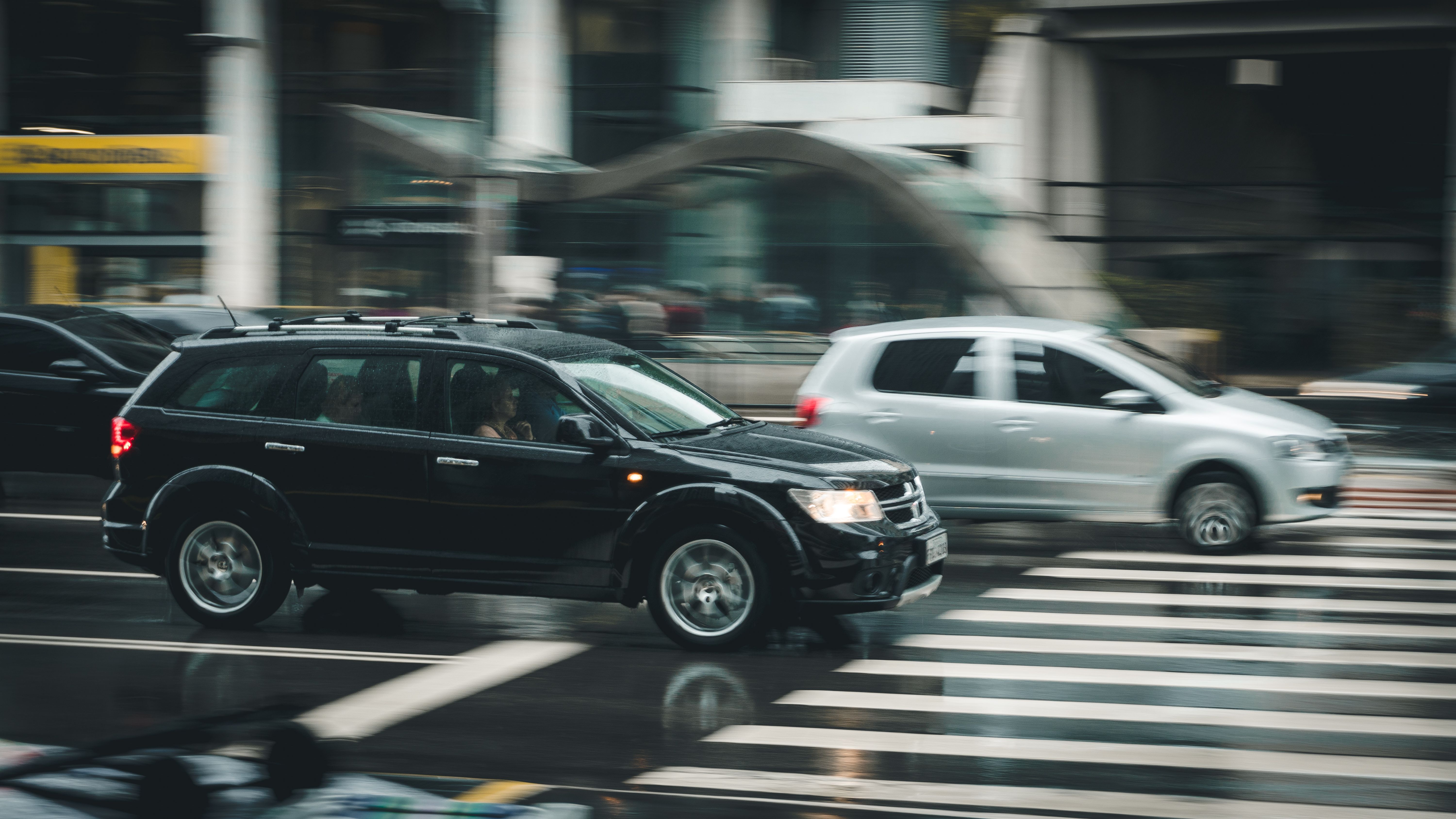Black SUV Beside Grey SUV Crossing Pedestrian Line