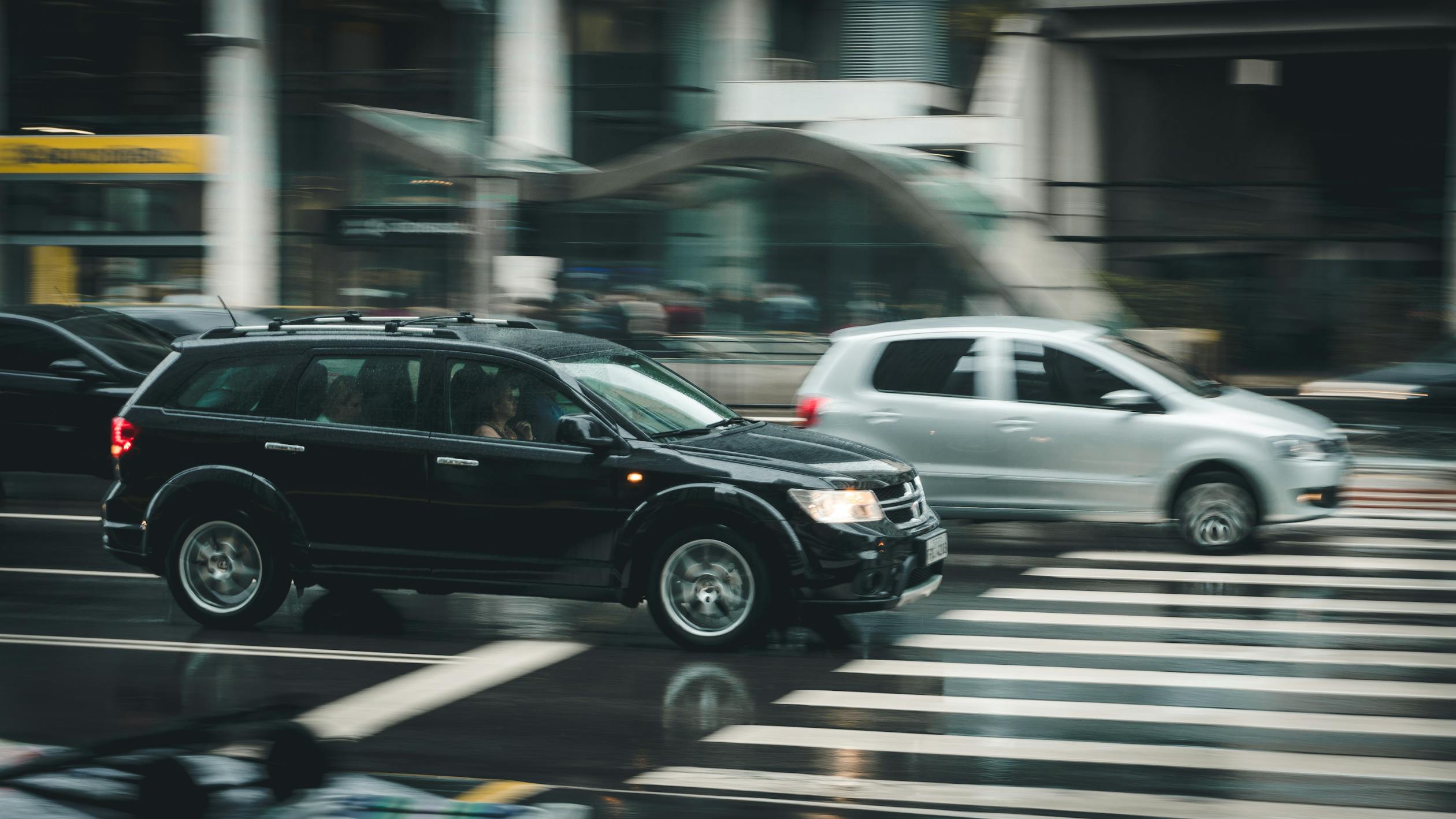 Car driving in the rain in a city