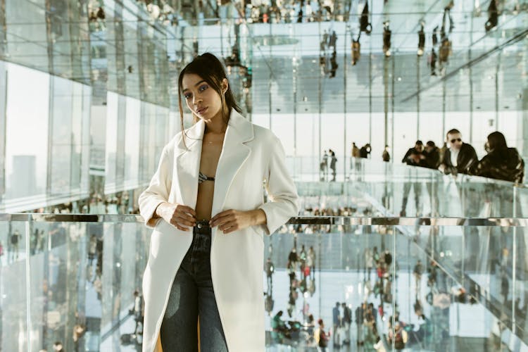 Woman Standing On First Floor Of Glass Office Bui