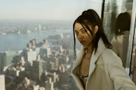 Woman in Beige Coat Looking at the City