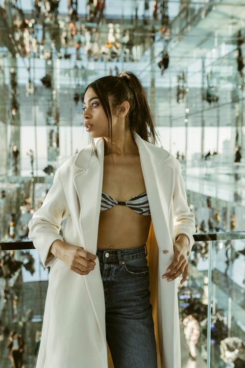 Free Fashionable woman in mirrored building in New York City. Stock Photo