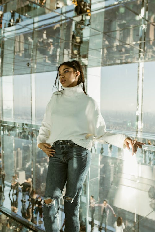 Woman Standing in Building with Mirror Ceil