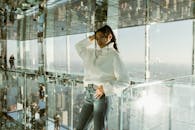 Woman in Sweater Posing in Building with Mirror Ce