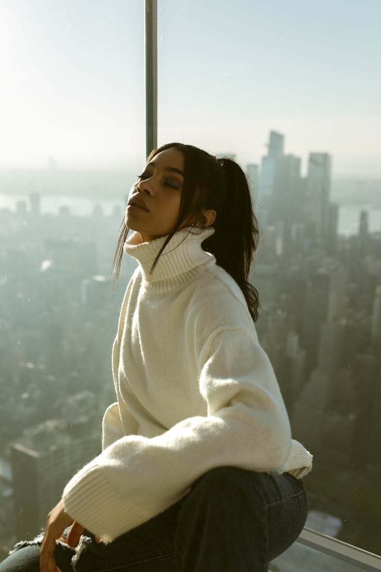 Woman In Oversized Sweater Sitting On Observation Tower In New York