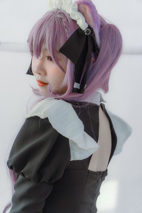 Free Side profile of a cosplayer with purple hair in a black and white outfit. Stock Photo