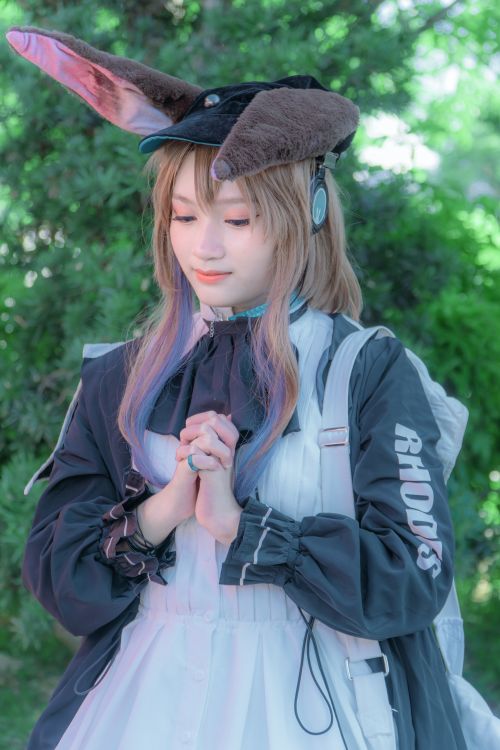 Free Cosplayer dressed as an anime character poses outdoors in costume with rabbit ears. Stock Photo