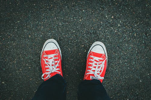 Person Wearing a Red Converse All-Star Shoes
