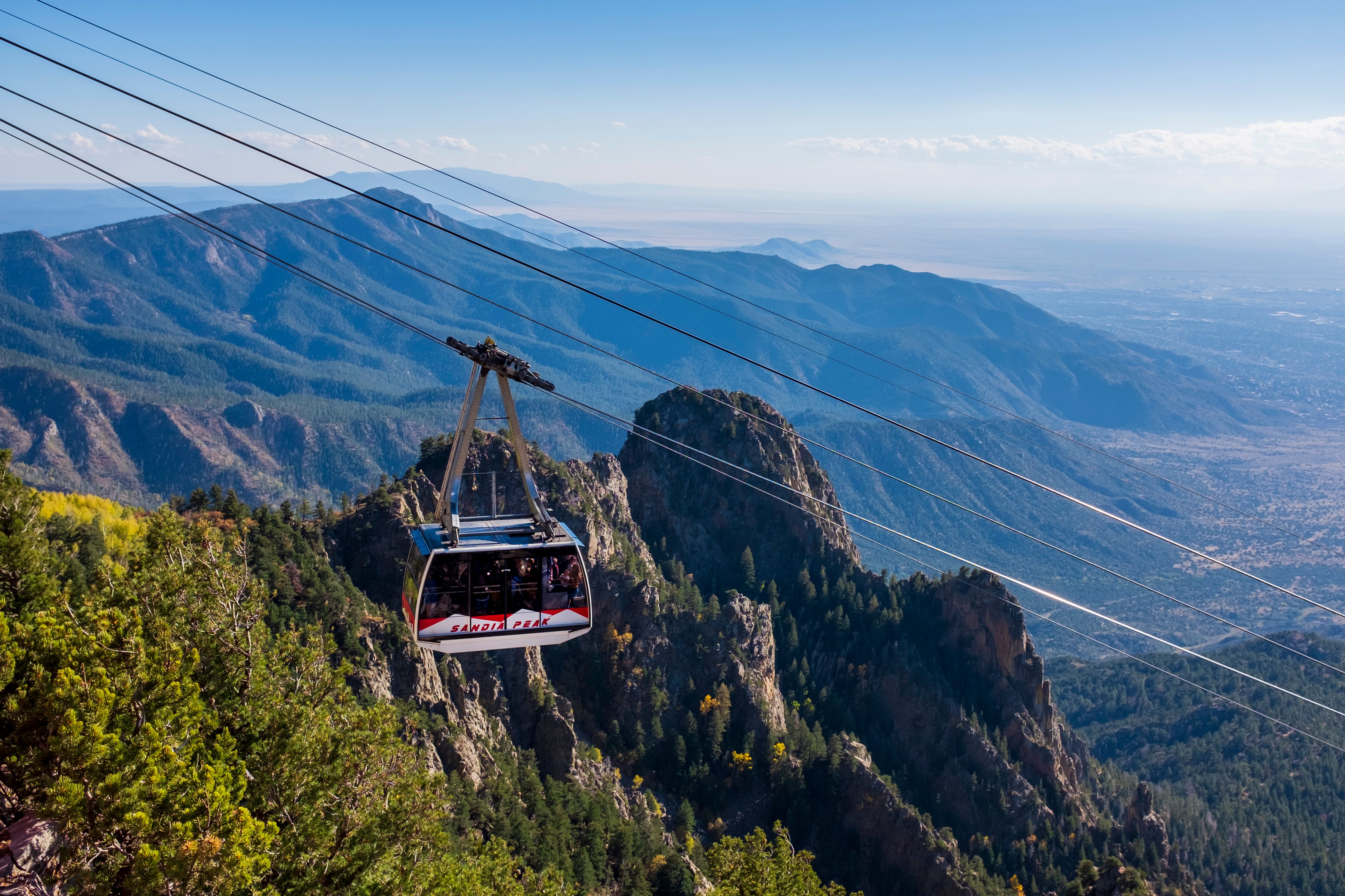 Experience the scenic ride of the Sandia Peak Tramway over majestic mountains in New Mexico, USA.