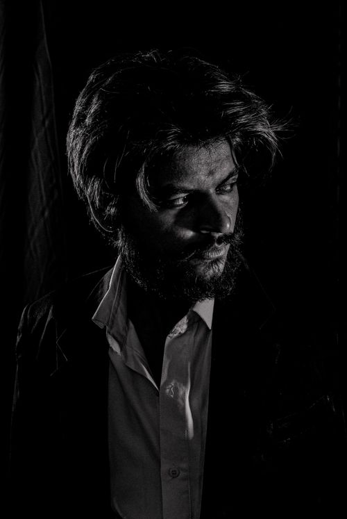 Free Intense monochrome portrait showcasing a bearded man in dramatic lighting. Stock Photo