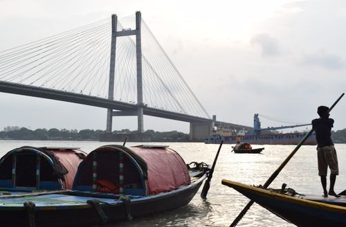 Free A scenic view of traditional boats with second Hooghly bridge in the background at Kolkata, India. Stock Photo