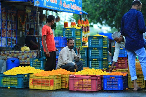  A Man Selling Yellow Flowers in Crates