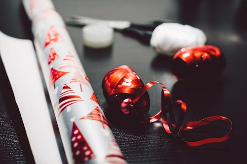 Close-up Photography of Red and White Ribbons on Black Surface